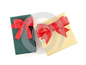 two gift boxes with red ribbon bow isolated on white background, flat lay close up top view