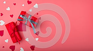 Two gifts for valentine`s day. Boxes in red packaging on a pink background with hearts. Banner. Place for your text