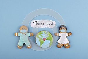 two gingerbread man medics in a mask a girl and a boy, the inscription thank you