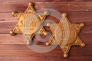 Two gingerbread sheriff star cookies