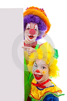 Two girl clowns holding empty text board