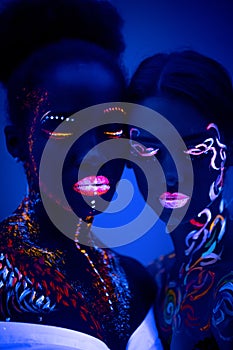 Two girl with fluorescent make-up isolated