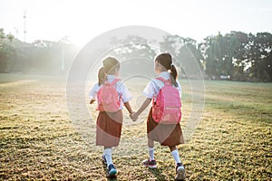 two girl friend primary school student walking together