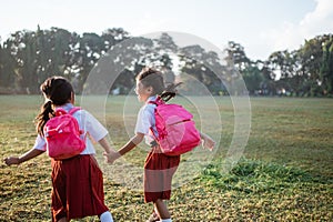 two girl friend primary school student walking together