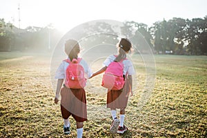 two girl friend primary school student walking together