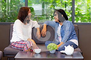 Two girl friends drinking coffee