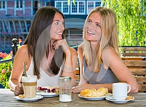 Two girl friends in outdoor cafe