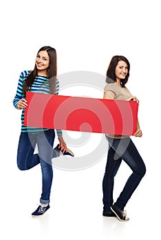 Two girl friends with red banner