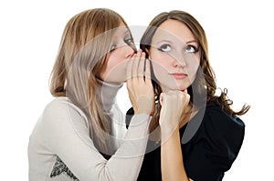 Two girl-friends tell gossips on an ear