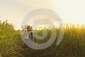 two girl happy open arm freedom at rice field