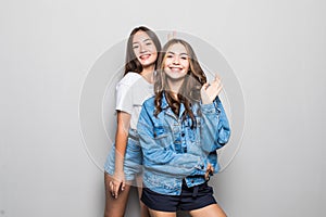 Two girl mixed race go crazy and have fun together isolated on gray background. Beautiful sporty women, positive emotion