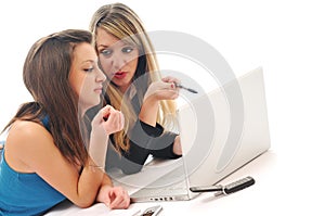 Two girl work on laptop