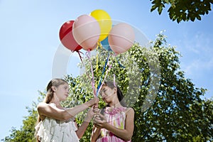 Two girlfriends with balloons