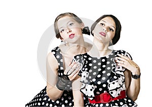 Two girlfriends dressed in pin-up style on a white background