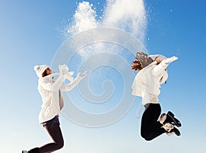 Two girlfriends have fun and enjoy fresh snow