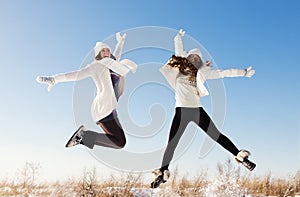 Two girlfriends have fun and enjoy fresh snow