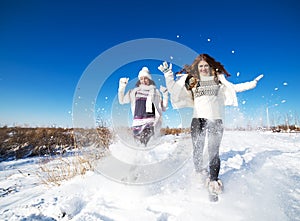 Two girlfriends have fun at winter day