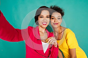 Two girlfriends having fun at azur studio background