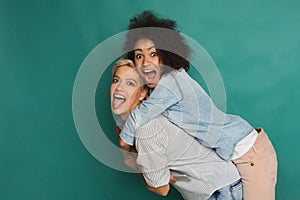 Two girlfriends having fun at studio background