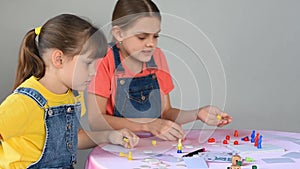 Two girlfriends at home playing board games did not share the chips