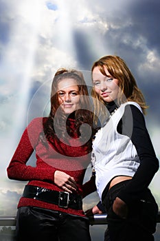 Two girlfriends over dramatic sky