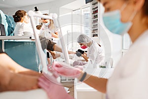 Two girlfriends, pedicure process in beauty salon