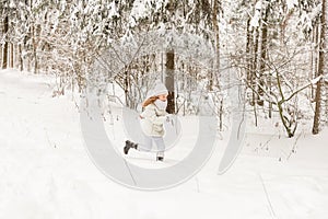 Two girlfriends playing in a winter forest.