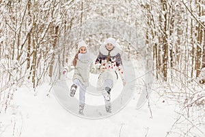 Two girlfriends playing in a winter forest.