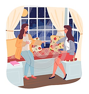 Two girlfriends sitting near window at night and talking with cup of tea or coffee, sitting at couch