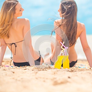 Two girlfriends on the summer beach