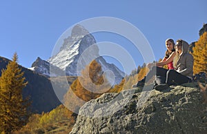 Two girls and autumn scene in Zermatt with Matterhorn mountain
