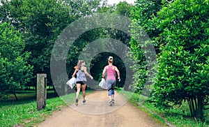 Two girls on back doing plogging