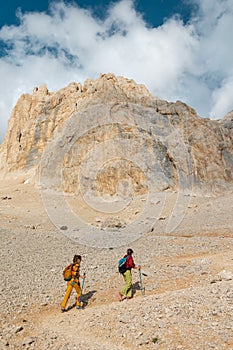 two girls with backpacks on a hike. hiking and travel in the mountains