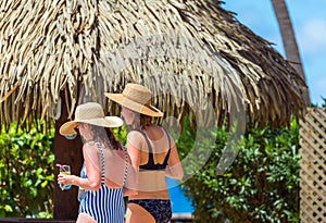 Two girls in bathing suits on the city beach, Rarotonga, Aitutaki, Cook Islands. With selective focus