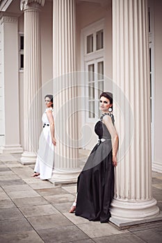 Two girls in black and white long dresses