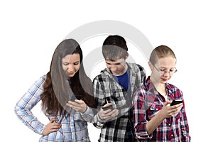 Two girls and boy with cell phones