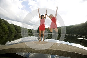 Two Girls on a Bridge Jump for Joy