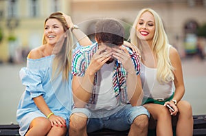 Two girls chatting, while the boy bored