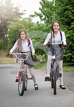 Two girls commuting to school on bicycles