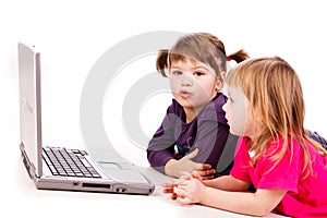 Two girls at the copmuter playing