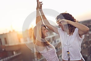 Two girls dancing on the building rooftop