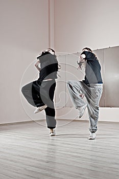 Two girls dancing synchronously