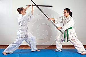 Two girls demonstrate martial arts working together