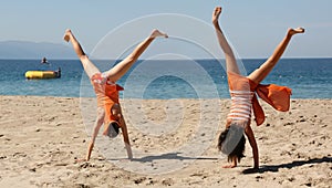 Two girls doing cartwheel photo