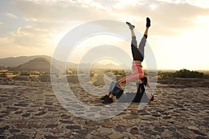 Two girls doing stunts in the Teotihuacan pyramids. Girls doing stunts on pyramids in Mexico. Pyramid of the sun, Teotihuacan.