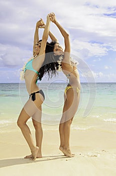 Two girls doing yoga at the beach