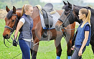 Two girls - dressage riders with horses