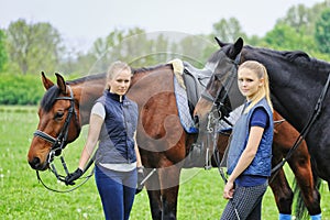 Two girls - dressage riders with horses