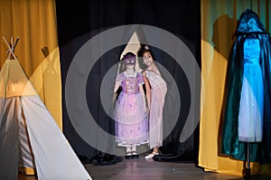 Two Girls Entering Stage in Theater