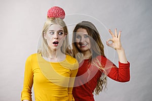 Two girls with fake brain